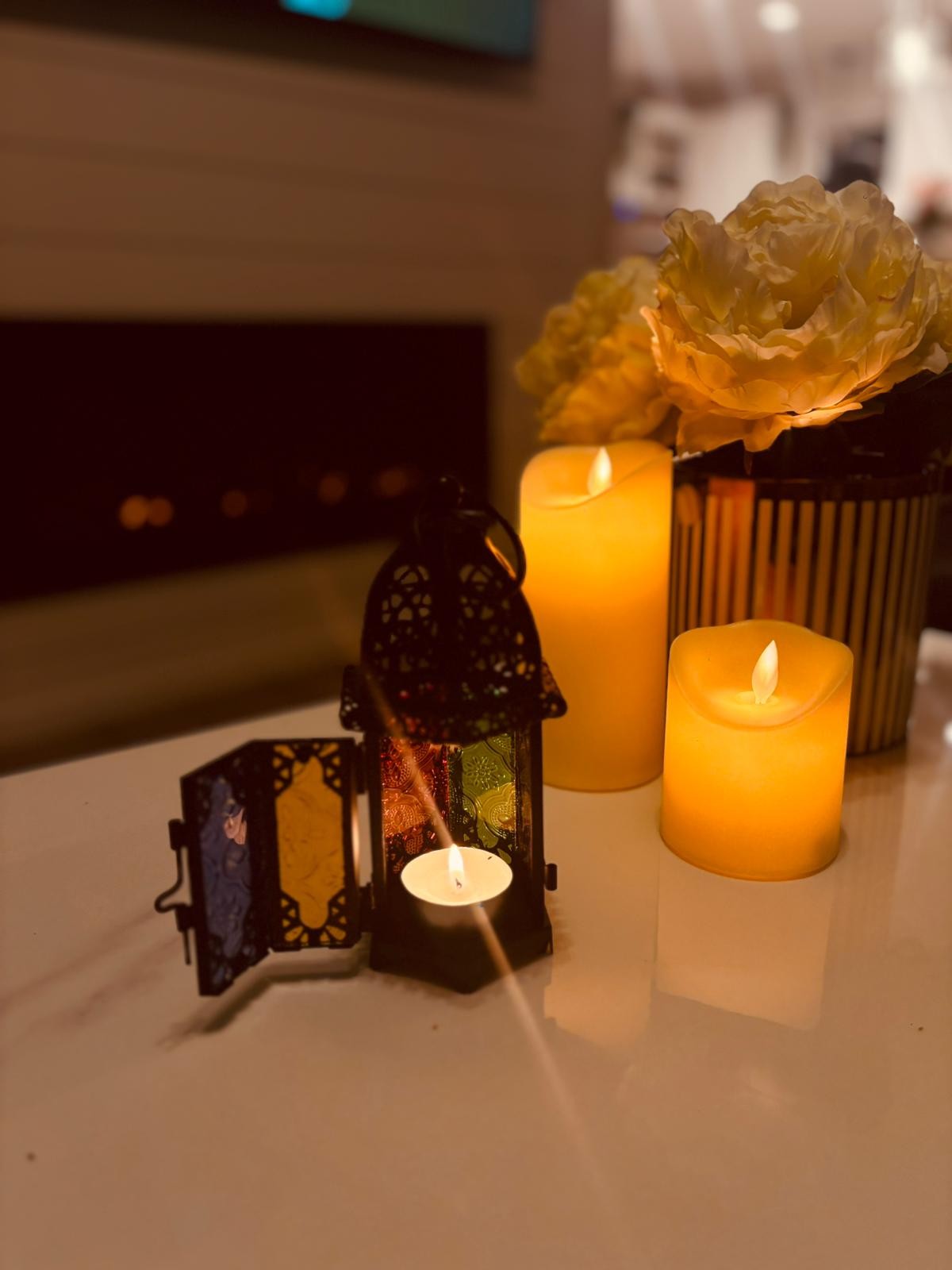 Atlas Maple Oasis Light Lantern with black metal frame and glass panels, perfect for outdoor or indoor ambient lighting.