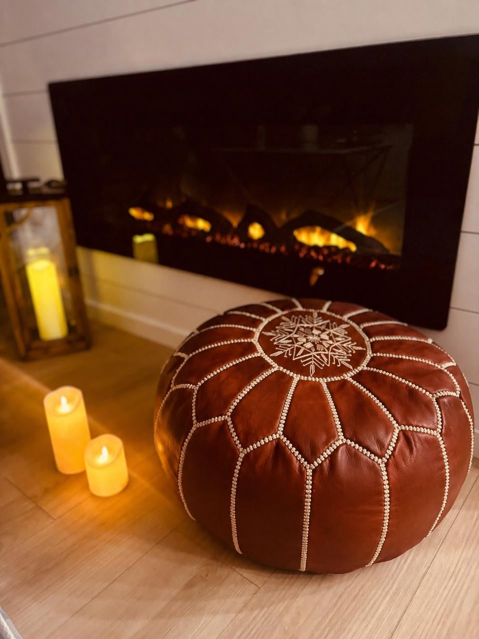 Atlas Maple Nomad Pouf with textured fabric and wooden legs, showcasing a modern, versatile seating or accent piece.