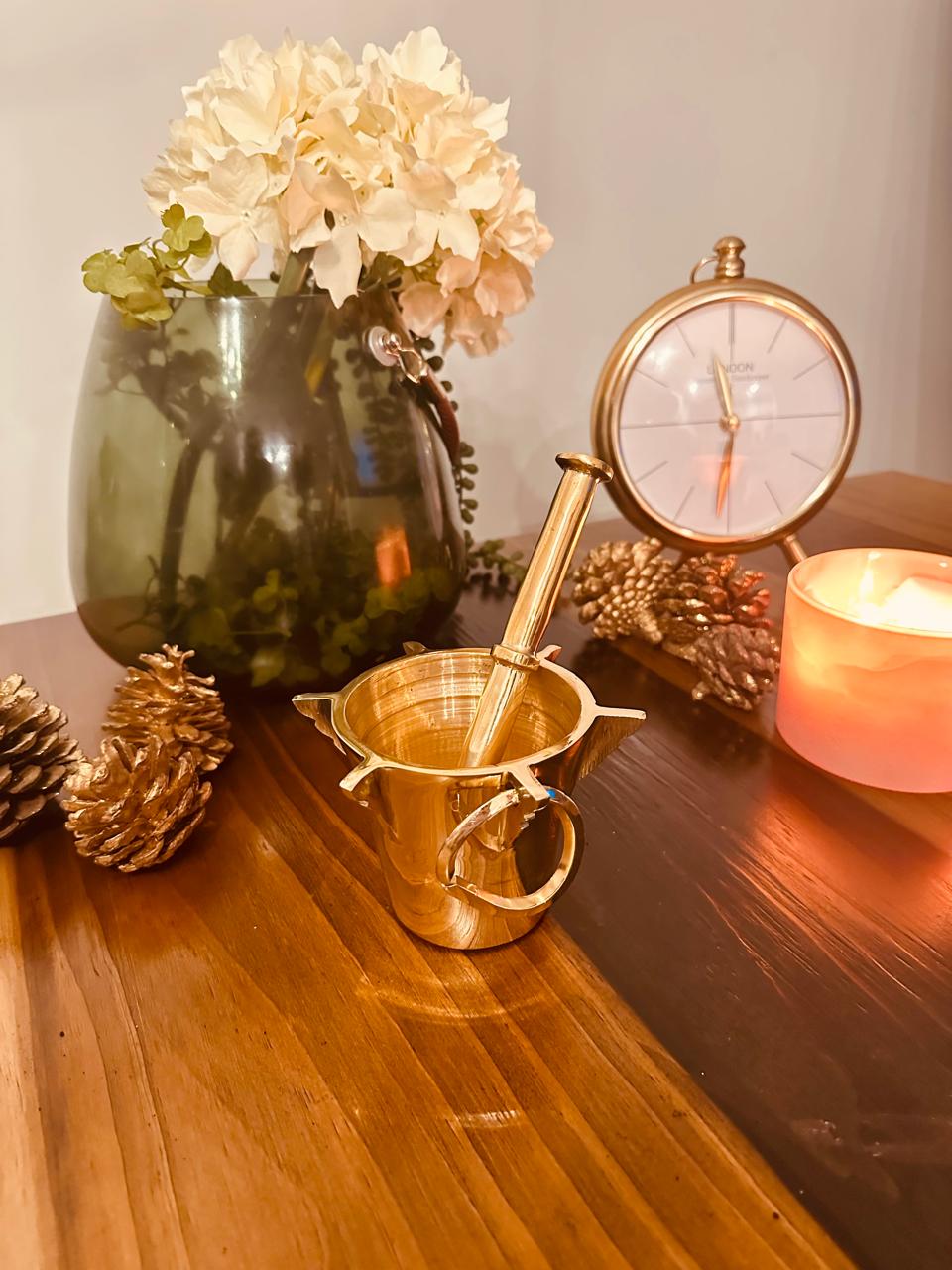 Atlas Maple Heritage Brass Mortar and Pestle set on a wooden surface, showcasing its polished brass finish and traditional design.