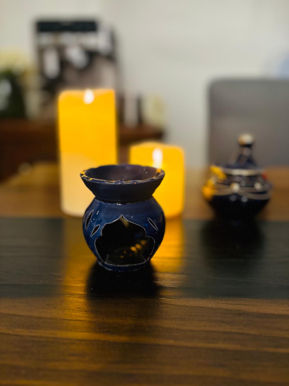 Atlas Maple Ember Glow Diffuser in blue with a sleek, modern design, emitting a warm, soothing light.
