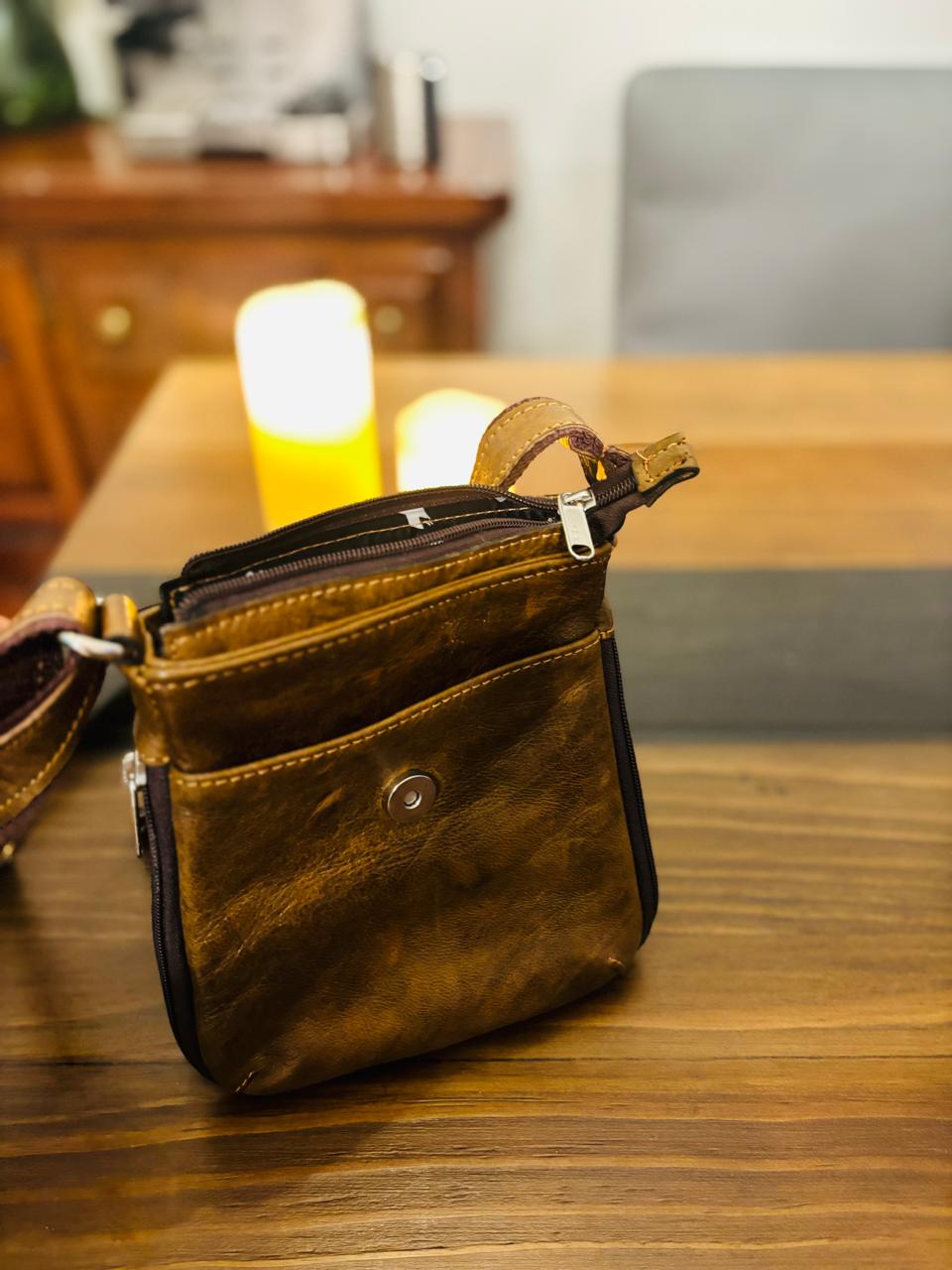Genuine leather crossbody bag by Atlas Maple with adjustable strap and minimalist design, shown against a neutral background.