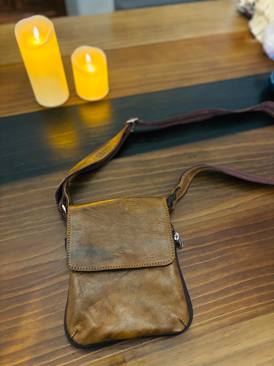 Genuine leather crossbody bag by Atlas Maple with adjustable strap and front zipper pocket, stylish and functional for daily use.