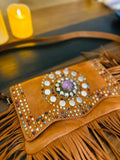 Atlas Maple Nomad Fringe Crossbody bag with leather strap and decorative fringe detailing, displayed against a neutral background.