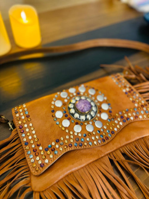 Atlas Maple Nomad Fringe Crossbody bag with leather strap and decorative fringe detailing, displayed against a neutral background.