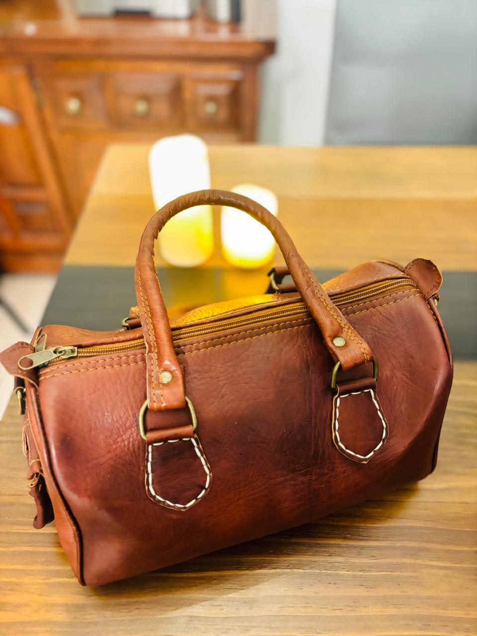 Atlas Maple Nomad Leather Weekender bag with sturdy handles and spacious interior, perfect for travel and weekend trips.